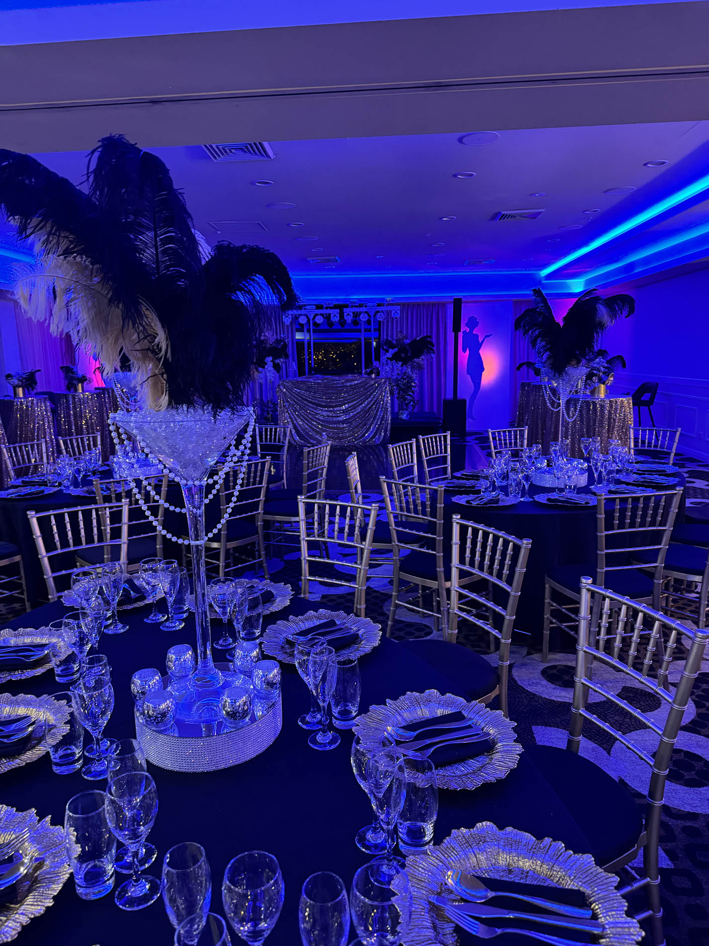 Gatsby-themed VIP lounge with black velvet seating and gold shimmer wall