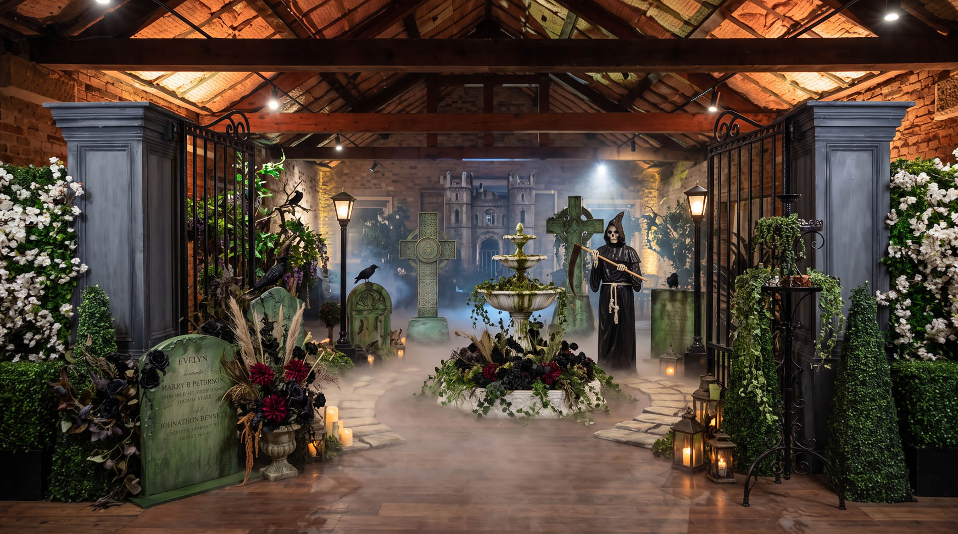 Graveyard styling with gravestones, black florals, urns and a hooded reaper figure
