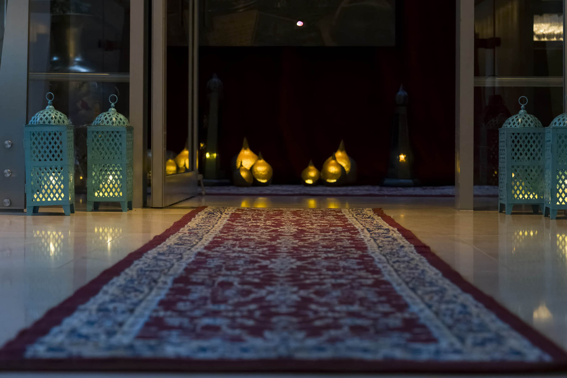 Layered draping, cushions and lantern light forming the Moroccan lounge setting